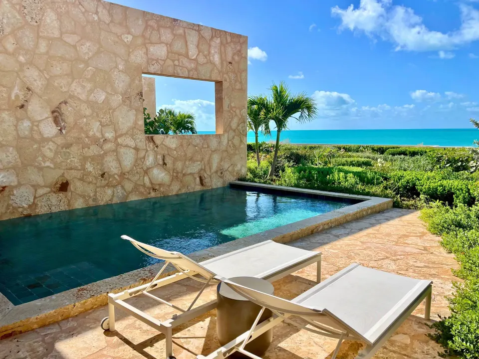 Private pool terrace with two loungers and ocean view at The Strand Turks and Caicos.