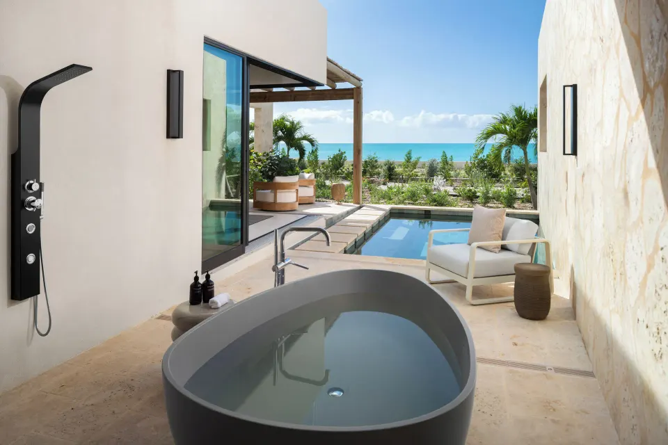 Outdoor soaking tub, shower, and pool terrace at The Strand Turks and Caicos.