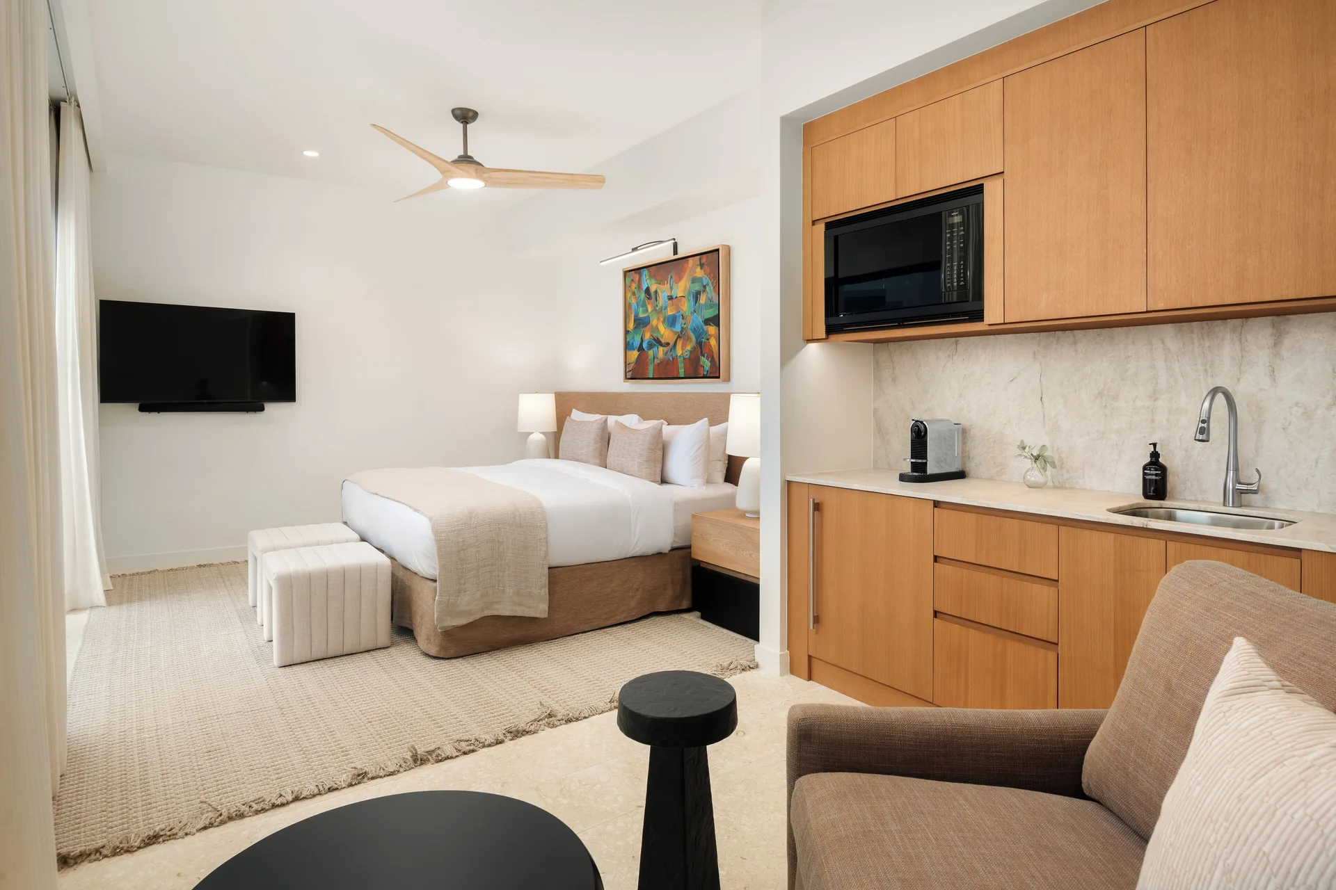 Third-floor suite with king bed and kitchenette at The Strand Turks and Caicos.