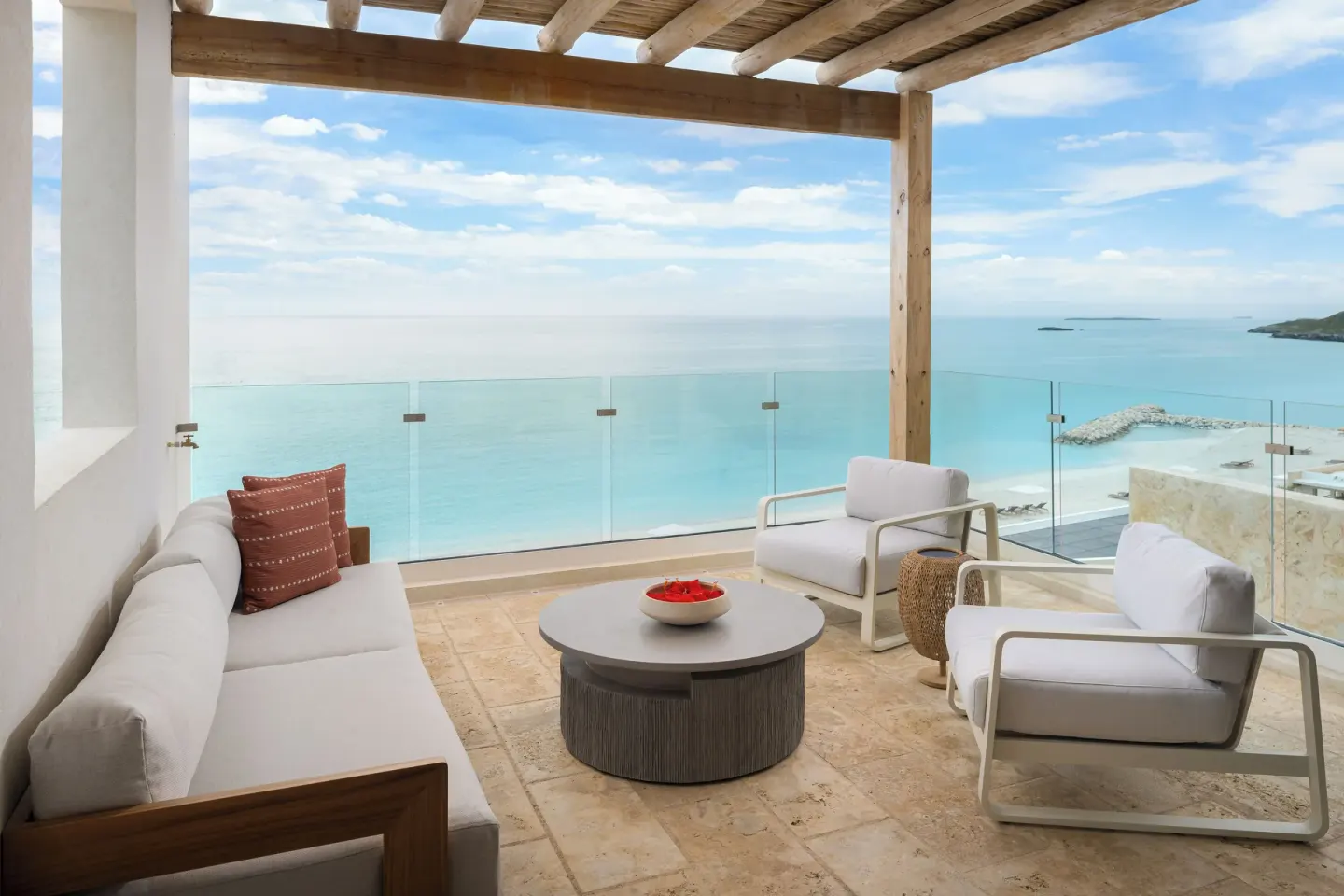 Third-floor suite terrace with lounge seating and ocean view at The Strand Turks and Caicos.