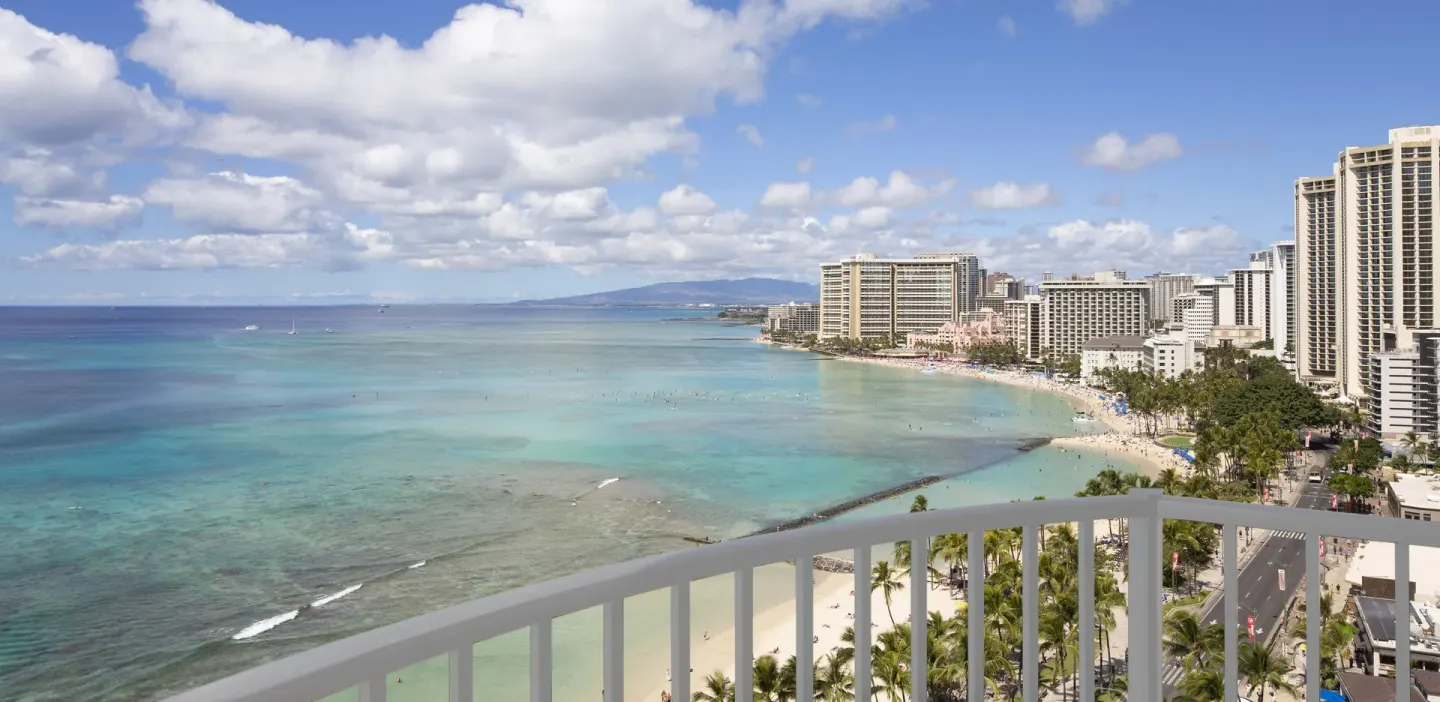 Balcony railing overlooking Waikiki Beach and ocean at The Twin Fin Hotel.