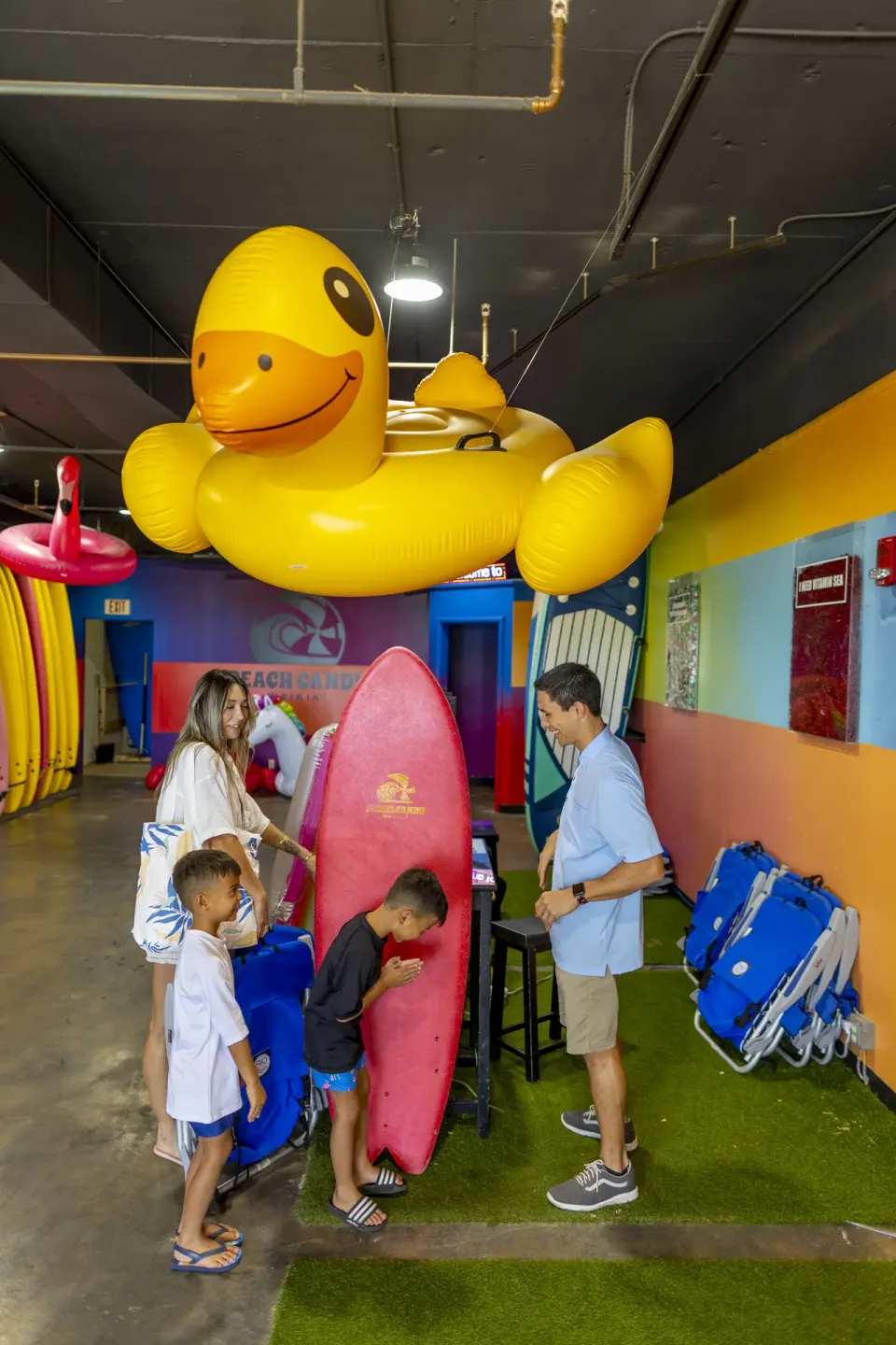 Family in colorful beach gear rental room at The Twin Fin Hotel.