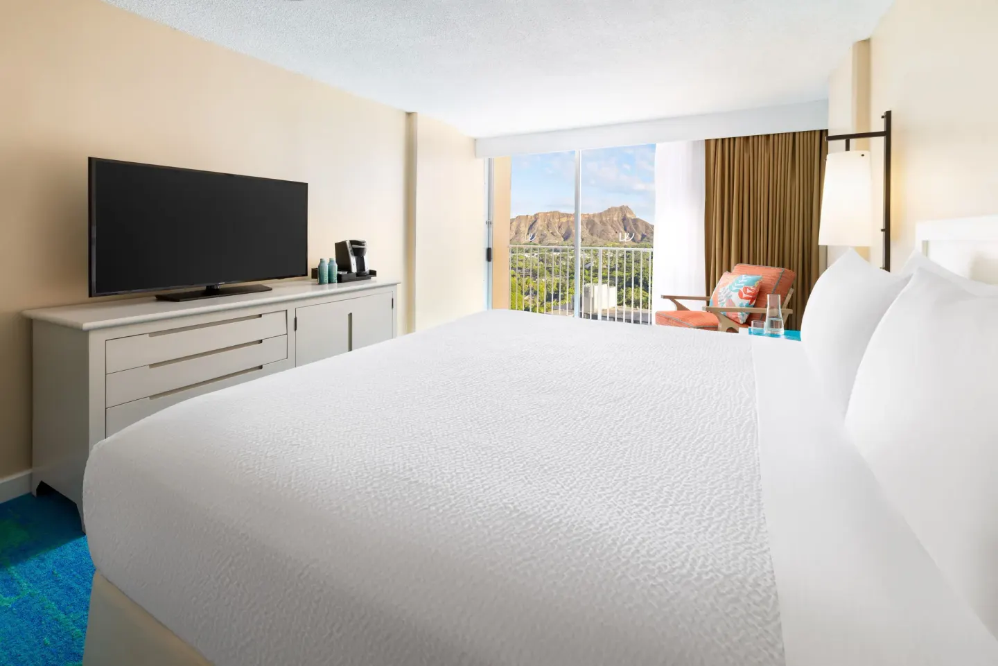 Guest room with king bed and Diamond Head view at The Twin Fin Hotel.