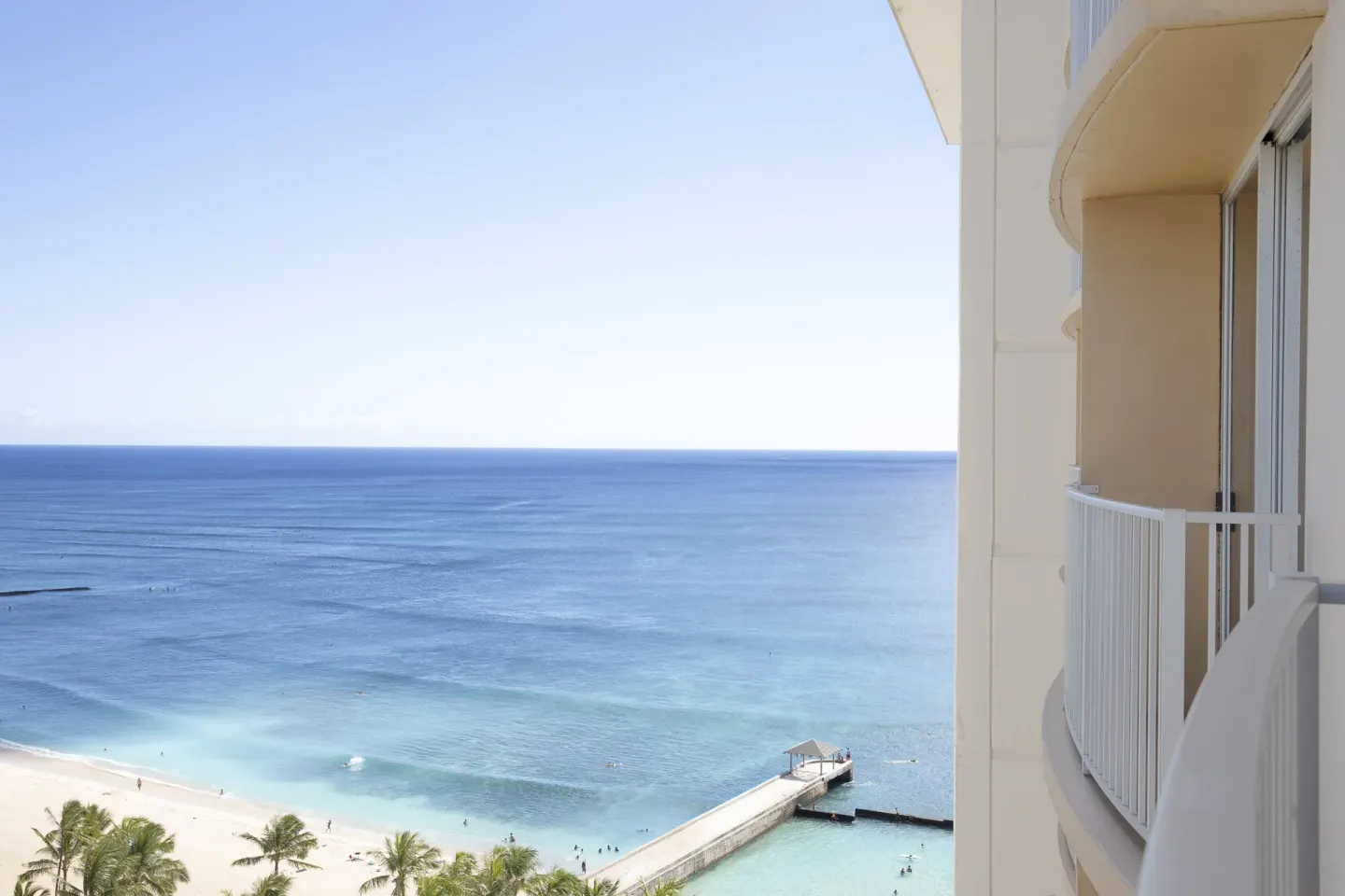 Guest room balcony and ocean view above Waikiki Beach at The Twin Fin Hotel.
