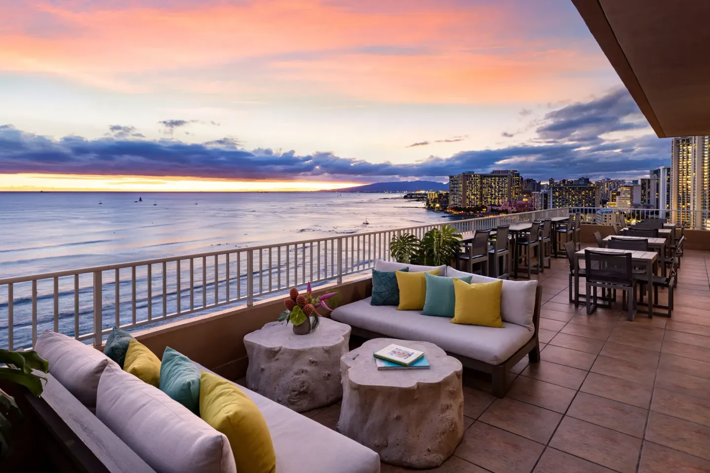Oceanfront terrace seating at sunset at The Twin Fin Hotel.