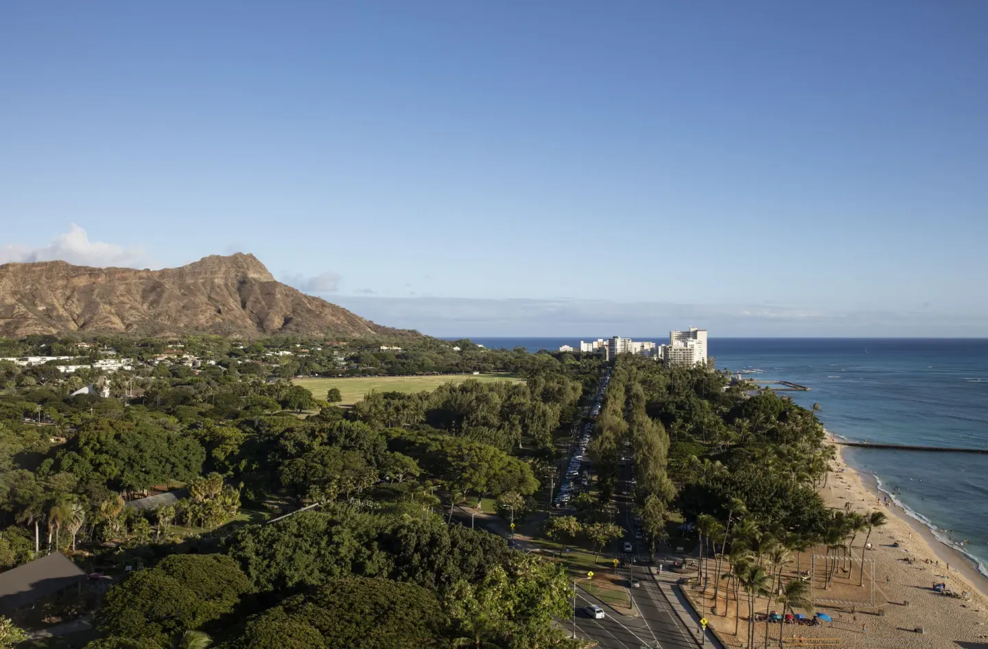 Panoramic view from The Twin Fin Hotel toward Diamond Head, parkland, beach, and ocean.