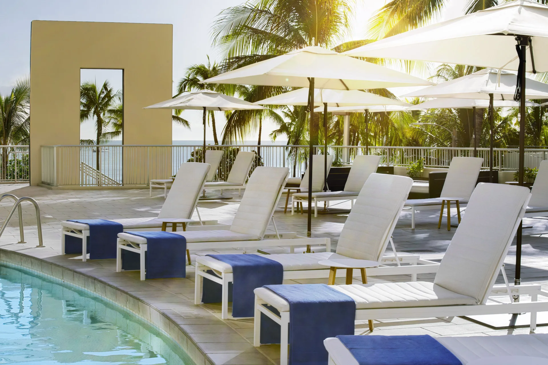Pool deck loungers and umbrellas at The Twin Fin Hotel.