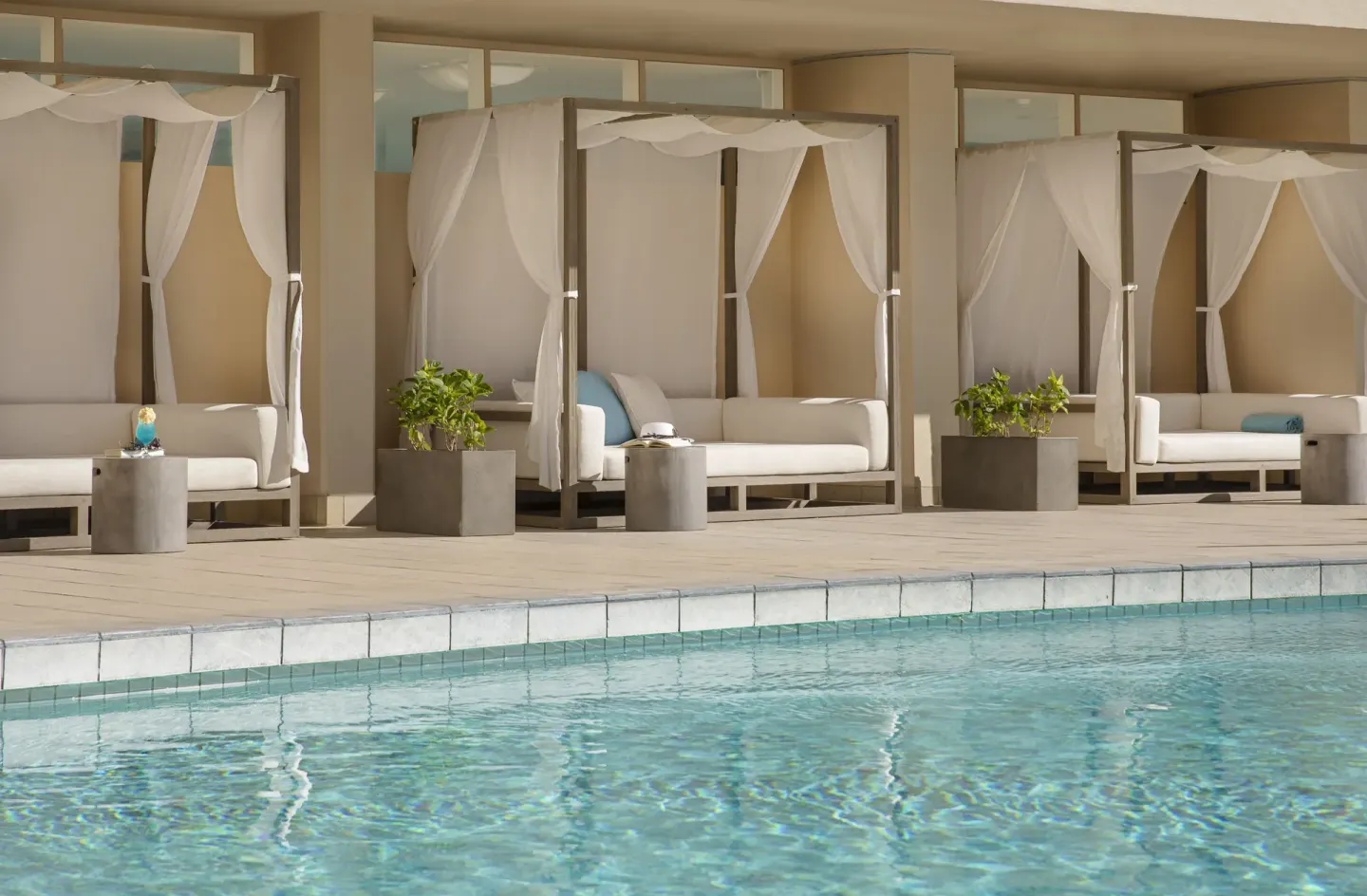Poolside cabanas beside the water at The Twin Fin Hotel.