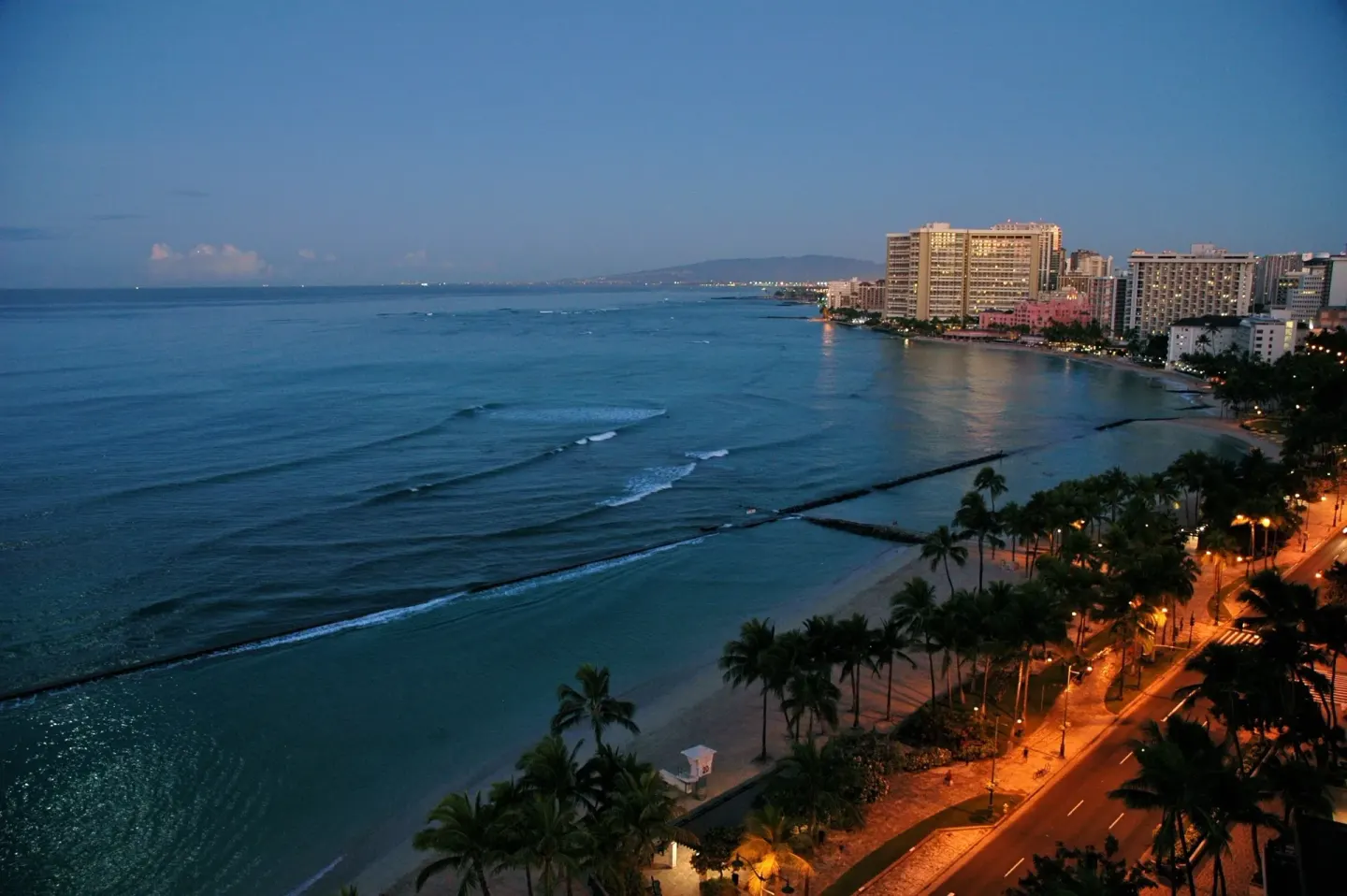 Twilight view of Waikiki shoreline and ocean from The Twin Fin Hotel.