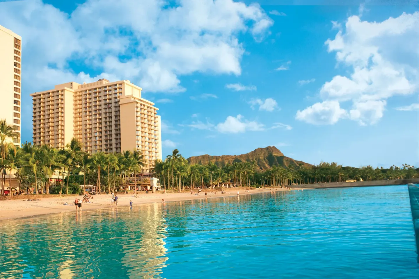 Waikiki beachfront, ocean, palms, and hotel tower near The Twin Fin Hotel.