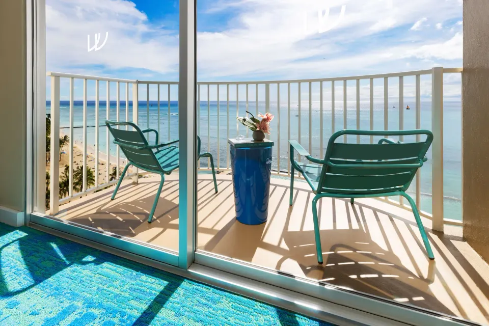 Lanai seating with ocean and beach views from The Twin Fin Hotel.