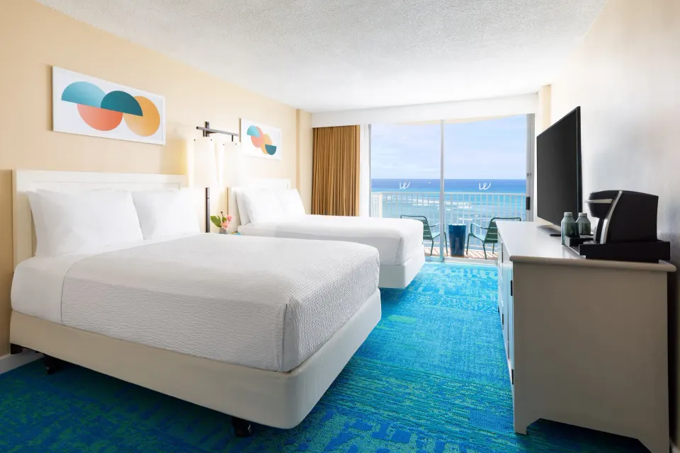 Oceanfront double-bed guest room with lanai at The Twin Fin Hotel.