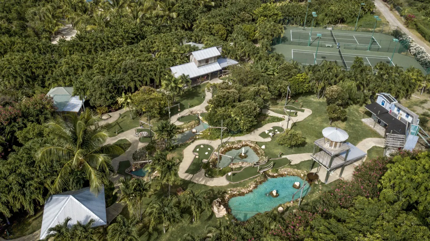 Aerial view of mini golf, tennis courts, and tropical grounds at The Verandah Antigua.