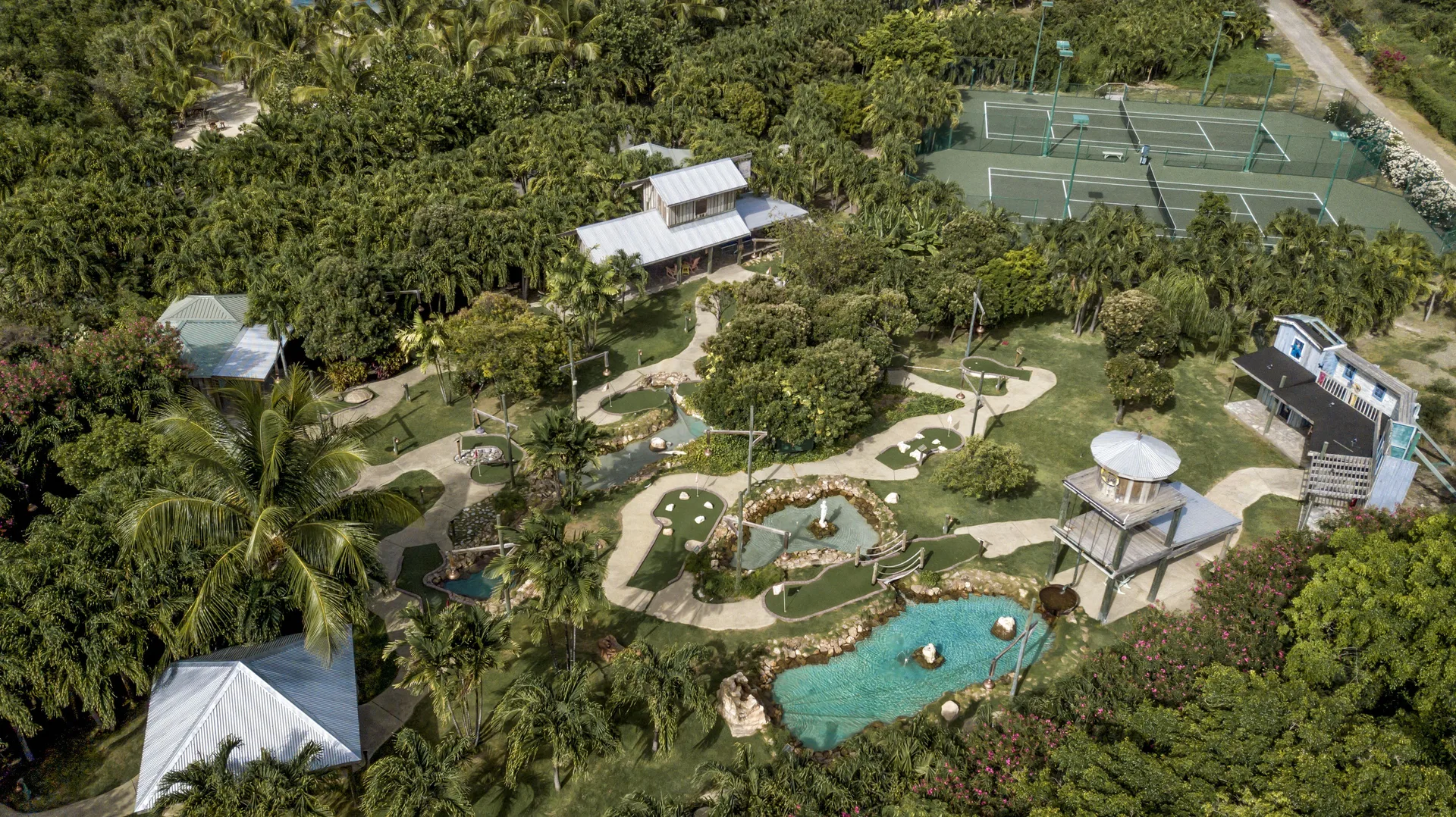 Aerial view of mini golf, tennis courts, and tropical grounds at The Verandah Antigua.
