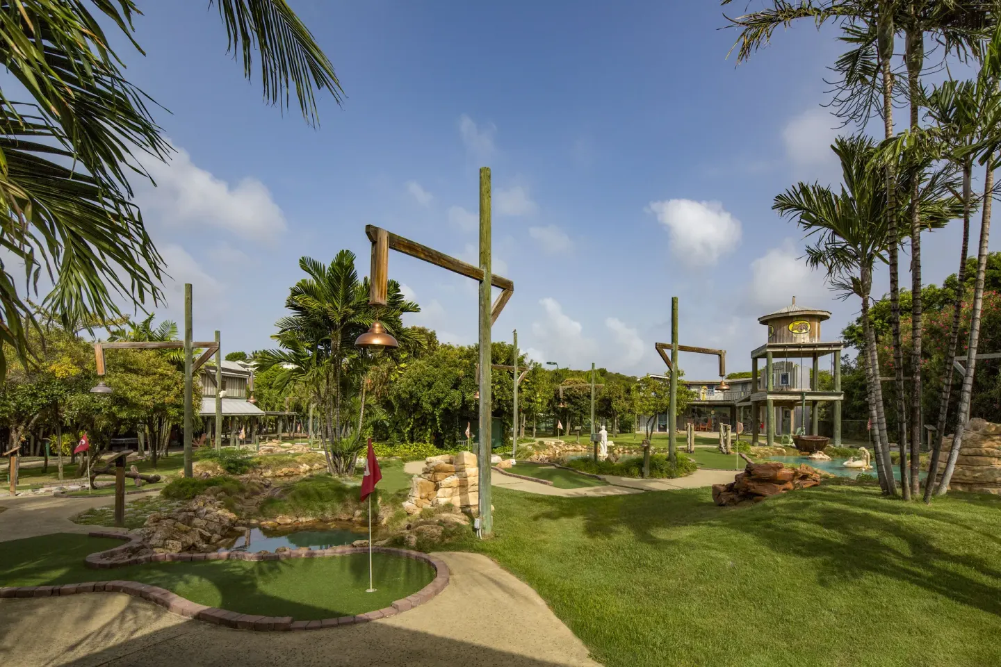 Mini golf course with palms, ponds, and pathways at The Verandah Antigua.