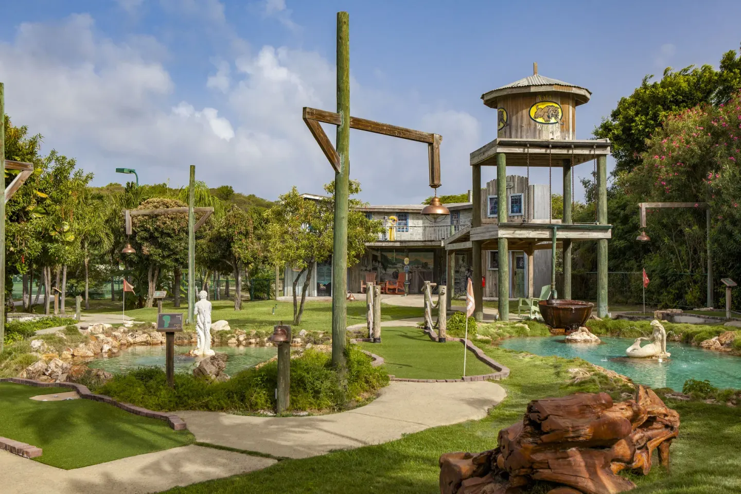 Mini golf greens, ponds, and a wooden tower structure at The Verandah Antigua.