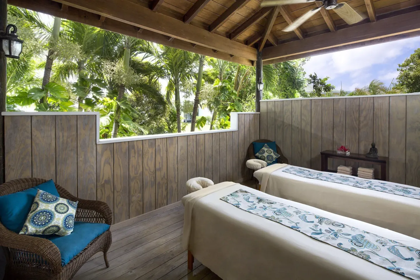 Open-air spa treatment area with two massage tables at The Verandah Antigua.