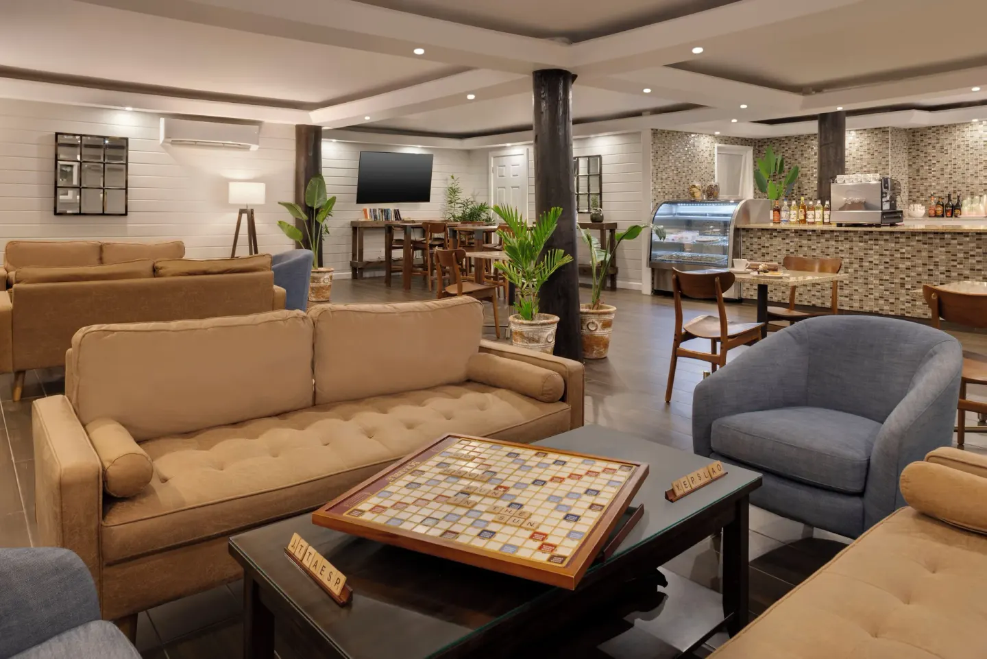 Cafe lounge with sofas, board games and a pastry counter at The Verandah Antigua.