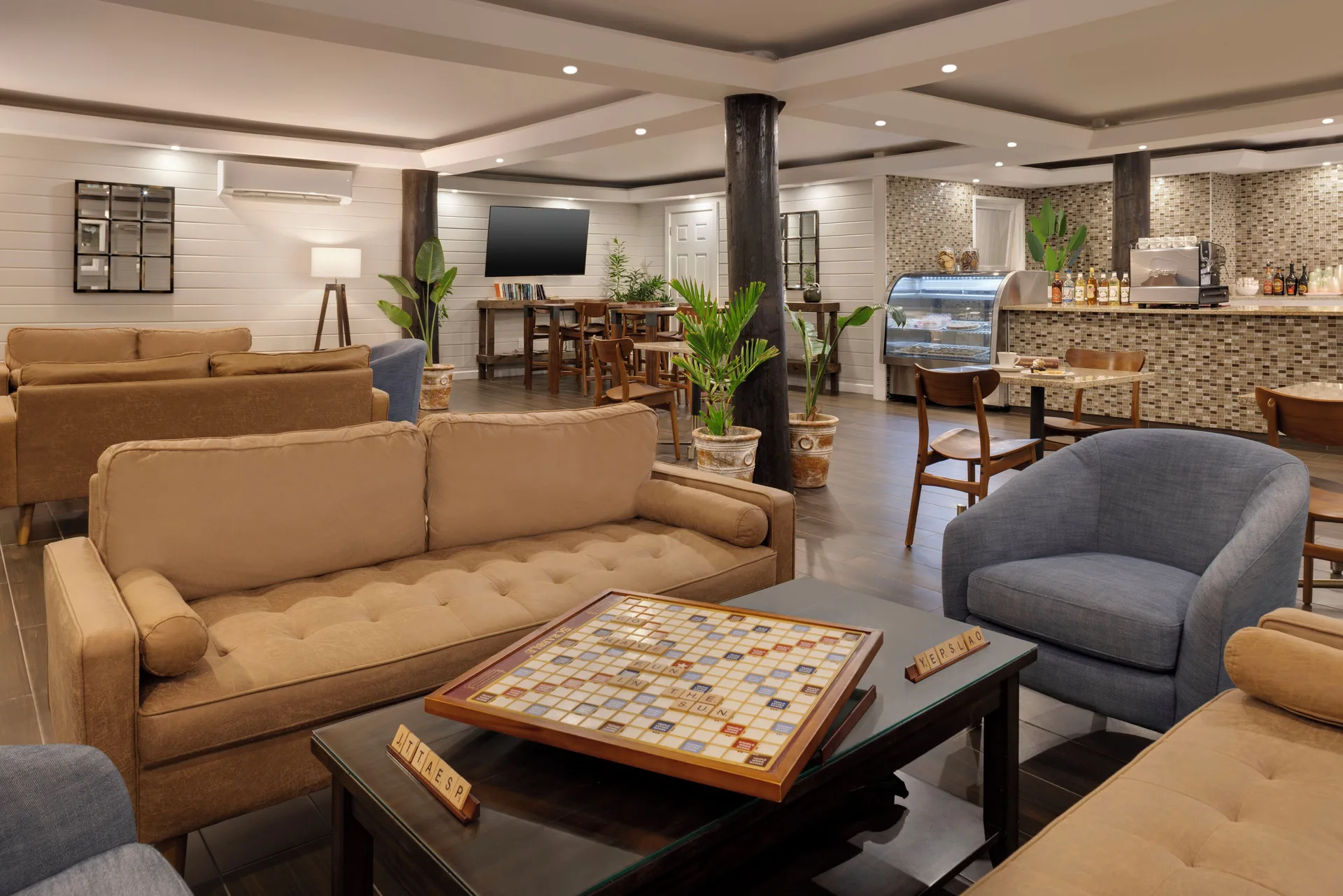 Cafe lounge with sofas, board games and a pastry counter at The Verandah Antigua.