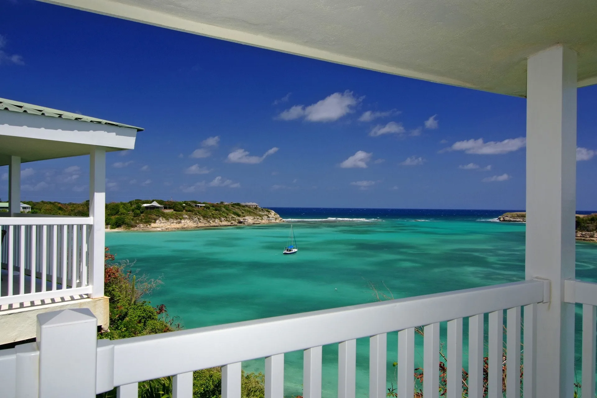 Waterfront suite balcony view over turquoise bay at The Verandah Antigua.