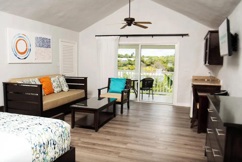 Waterfront suite lounge area with balcony doors at The Verandah Antigua.