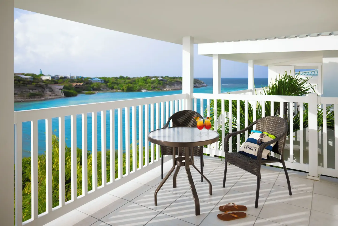 Waterfront suite terrace with chairs and bay view at The Verandah Antigua.