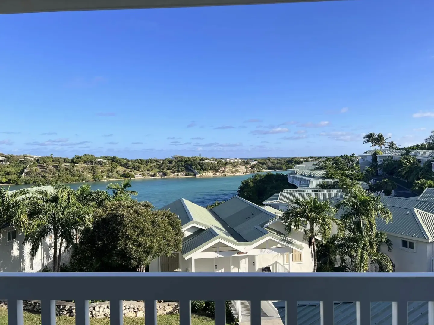 Waterview Suite balcony view over water and resort rooftops at The Verandah Antigua.