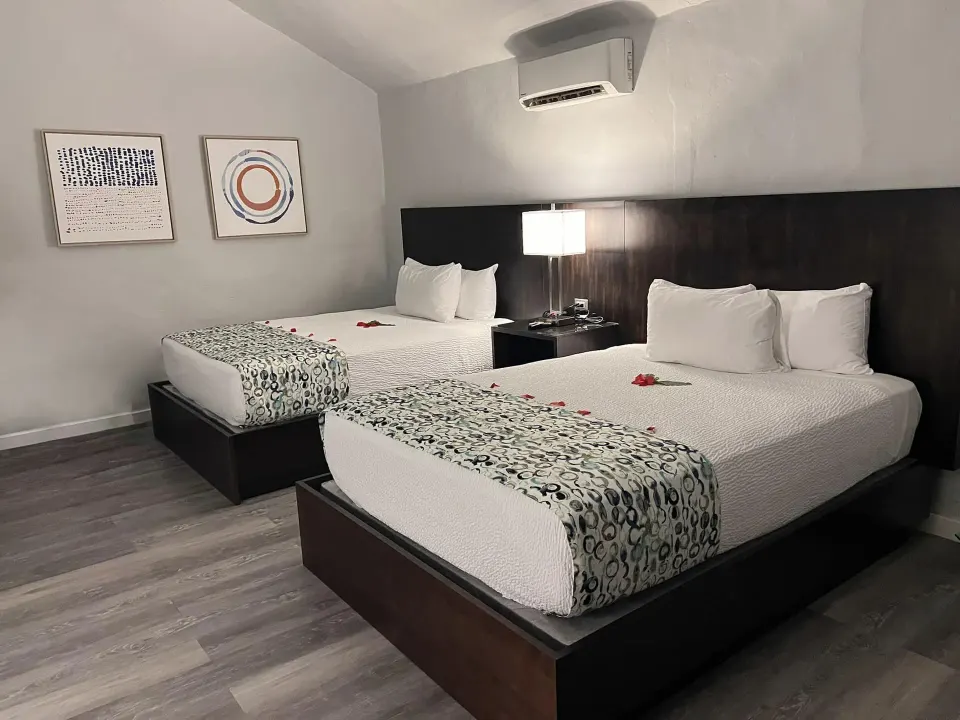 Waterview Suite bedroom with two queen beds at The Verandah Antigua.