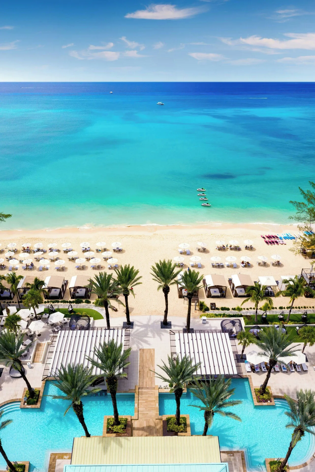 Pool, beach, and turquoise water at The Westin Grand Cayman Seven Mile Beach Resort & Spa.