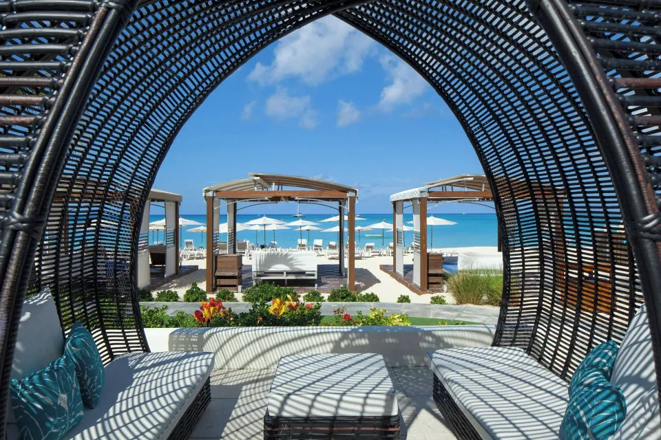 Beach cabanas seen from a shaded lounger at The Westin Grand Cayman Seven Mile Beach Resort & Spa.