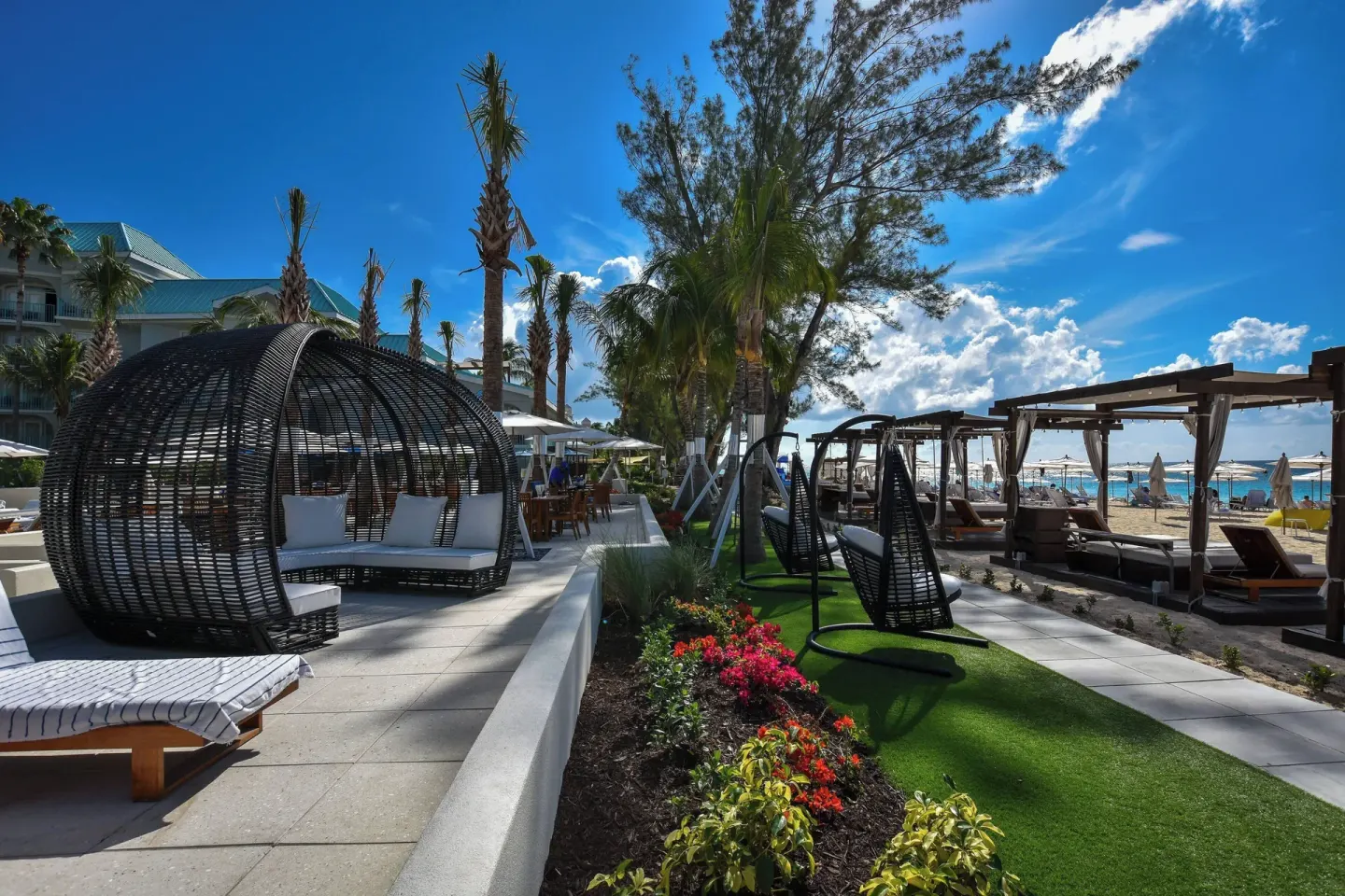 Garden walkway with beach cabanas at The Westin Grand Cayman Seven Mile Beach Resort & Spa.