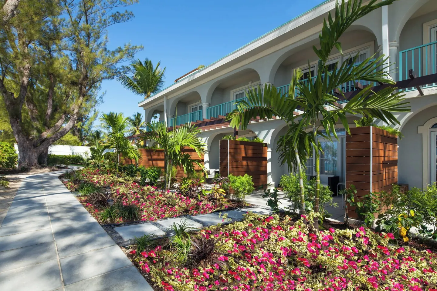 Garden walkway beside guest rooms at The Westin Grand Cayman Seven Mile Beach Resort & Spa.