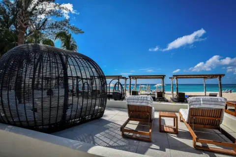 Oceanfront lounge chairs and cabanas at The Westin Grand Cayman Seven Mile Beach Resort & Spa.