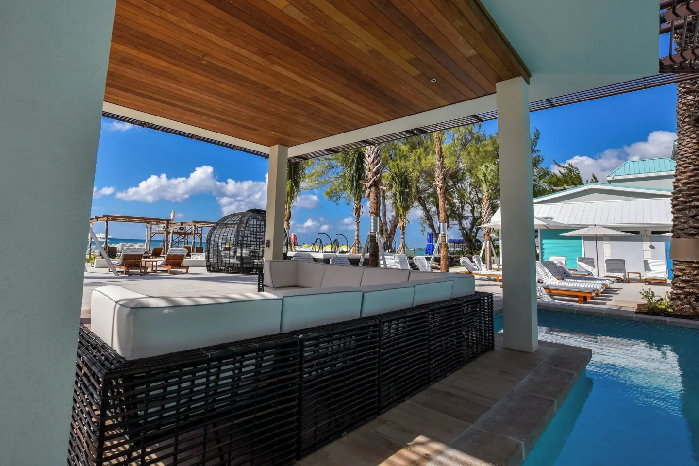 Shaded poolside seating at The Westin Grand Cayman Seven Mile Beach Resort & Spa.