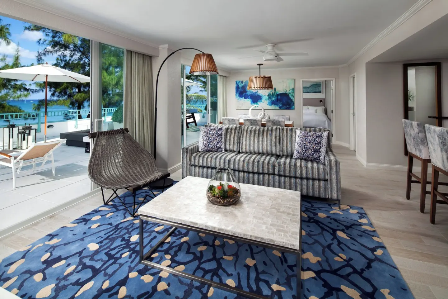 Suite lounge with terrace and ocean view at The Westin Grand Cayman Seven Mile Beach Resort & Spa.