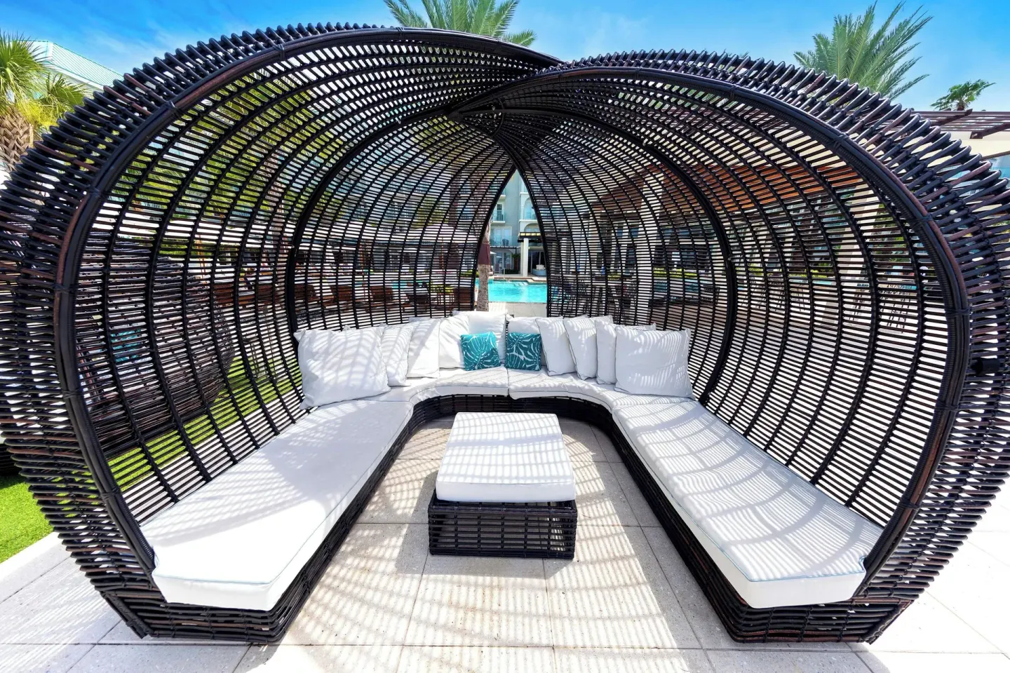 Woven cabana lounge by the pool at The Westin Grand Cayman Seven Mile Beach Resort & Spa.