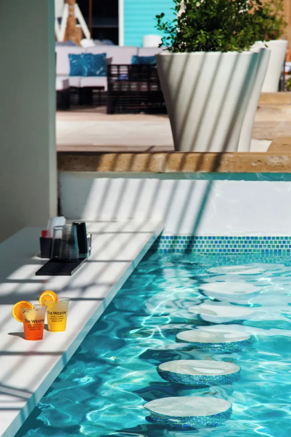 Colorful drinks beside a pool edge at The Westin Grand Cayman Seven Mile Beach Resort & Spa.