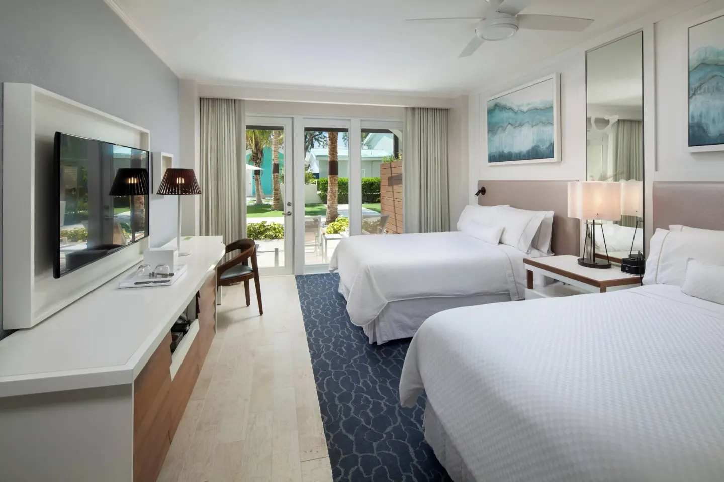 Partial Ocean View room with two beds and patio doors at The Westin Grand Cayman Seven Mile Beach Resort & Spa.