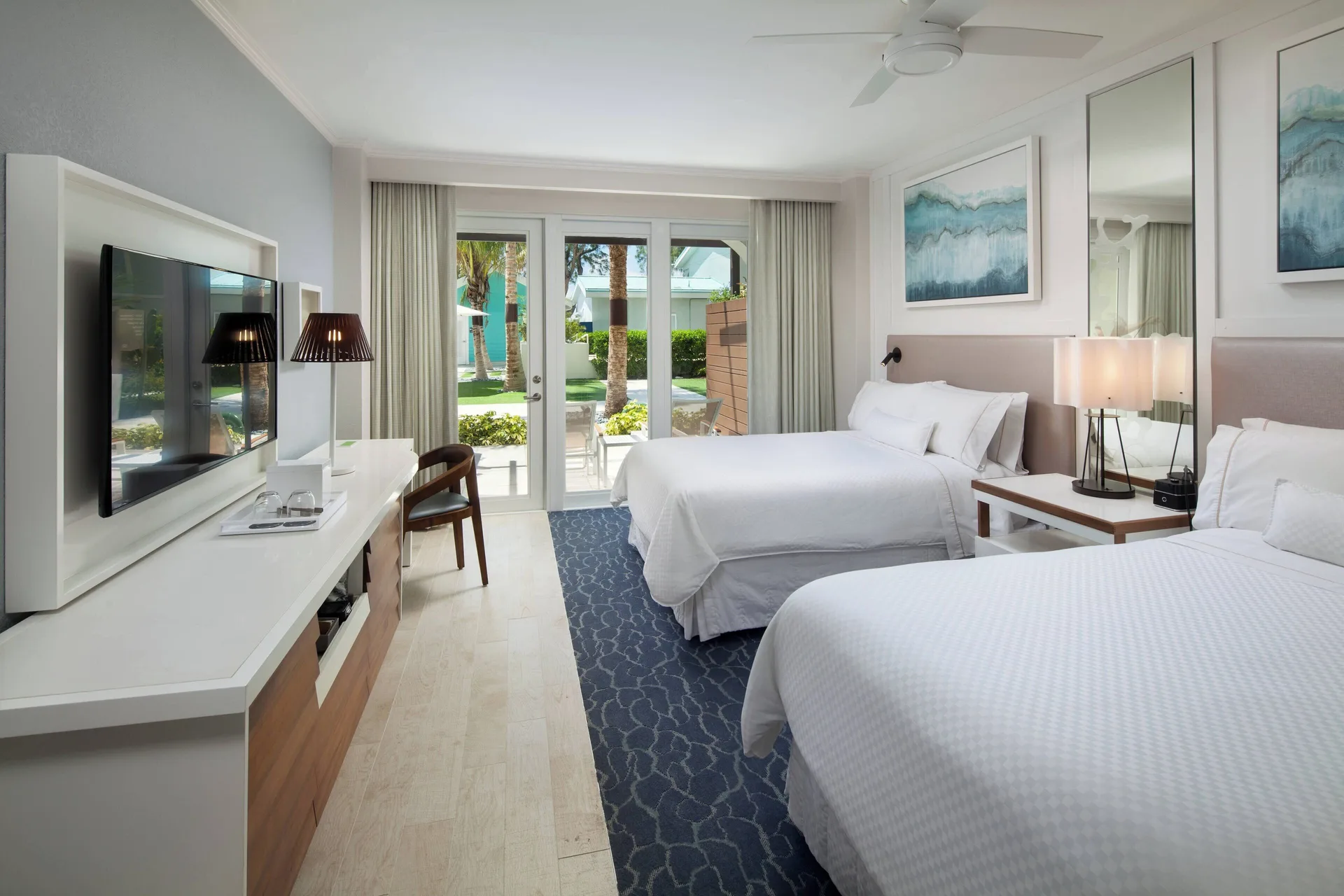 Partial Ocean View room with two beds and patio doors at The Westin Grand Cayman Seven Mile Beach Resort & Spa.