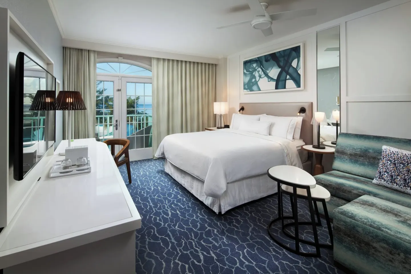 King room with sofa bed and balcony at The Westin Grand Cayman Seven Mile Beach Resort & Spa.