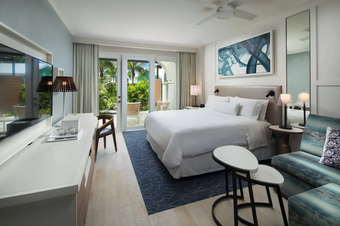Room with sofa bed and pool view at The Westin Grand Cayman Seven Mile Beach Resort & Spa.
