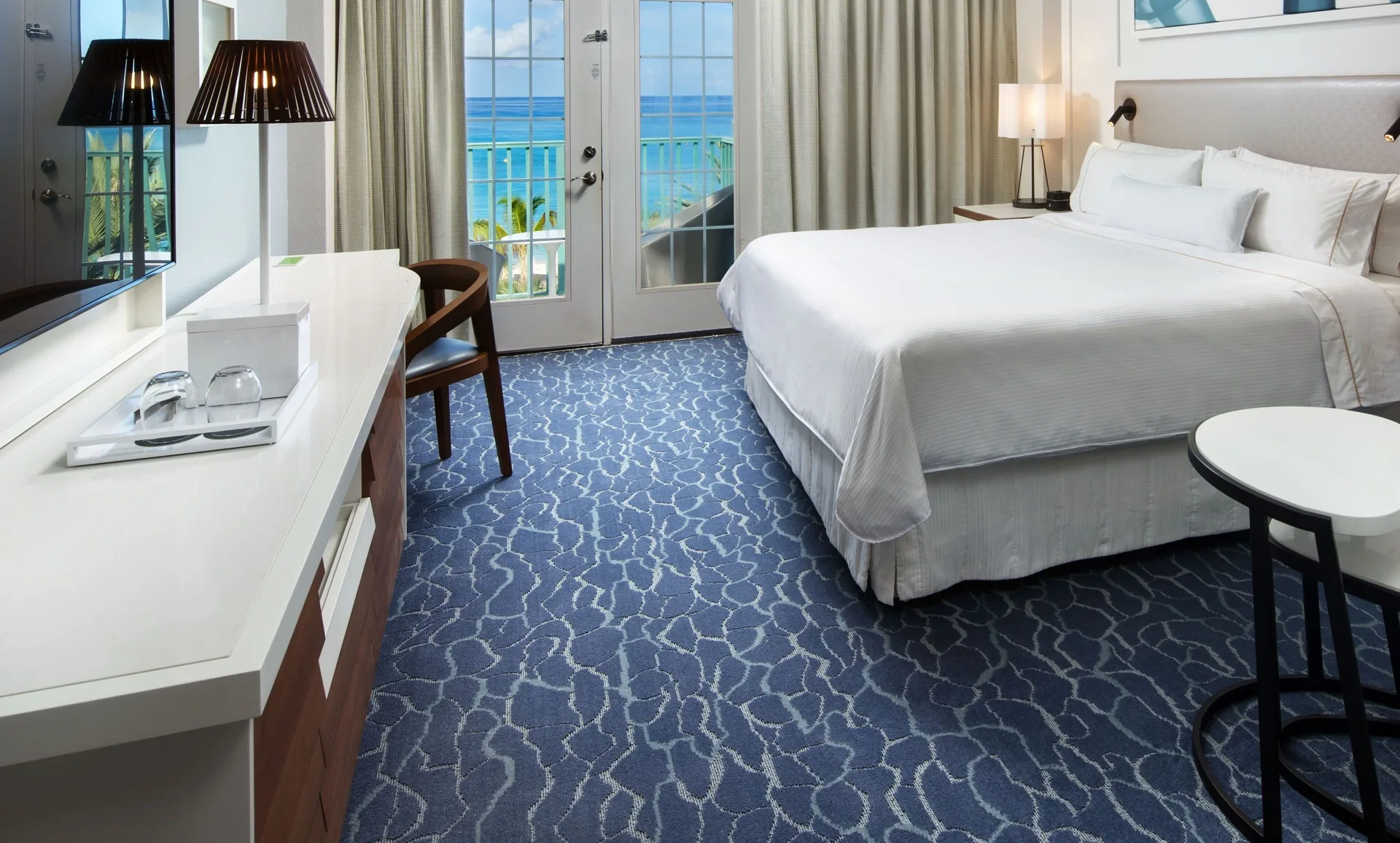 Pool view guest room with king bed at The Westin Grand Cayman Seven Mile Beach Resort & Spa.
