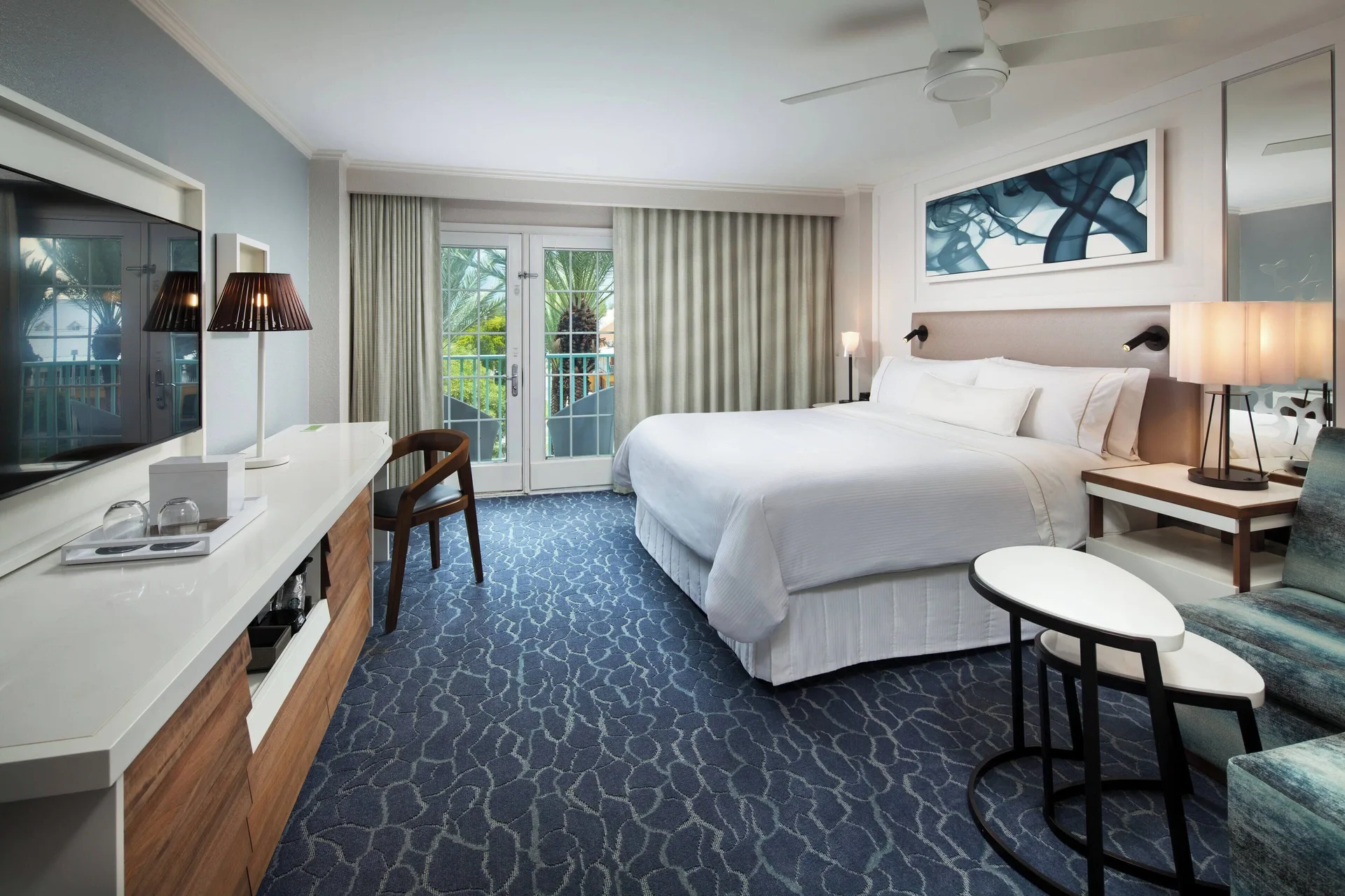 Room with sofa bed and balcony doors at The Westin Grand Cayman Seven Mile Beach Resort & Spa.
