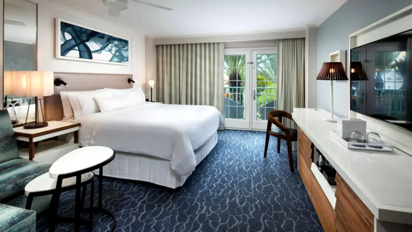 Guest room with king bed, sofa bed, and TV at The Westin Grand Cayman Seven Mile Beach Resort & Spa.
