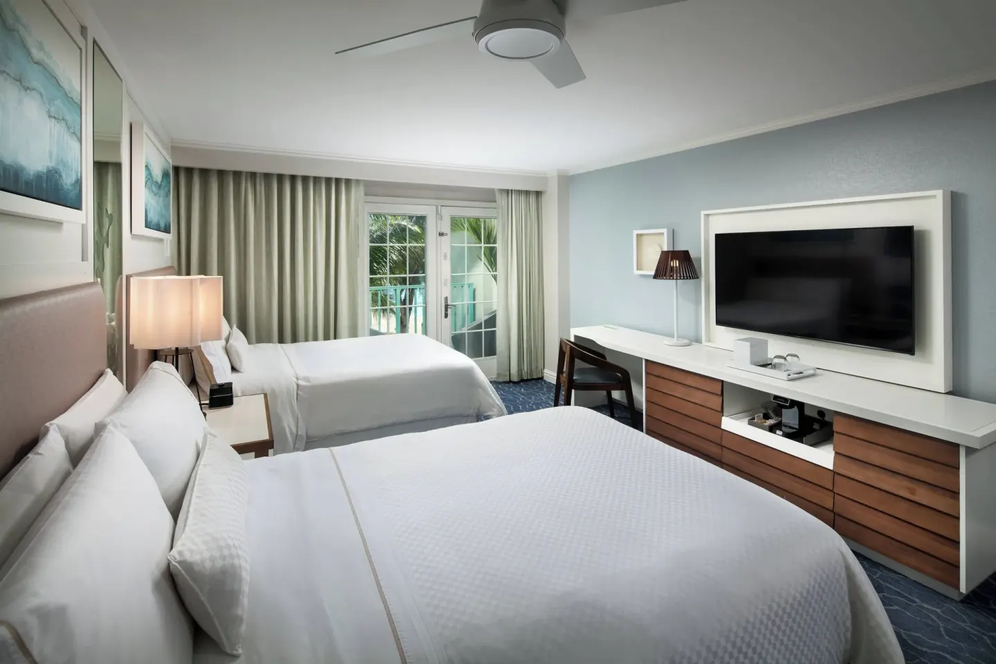 Two-bed guest room with balcony doors at The Westin Grand Cayman Seven Mile Beach Resort & Spa.