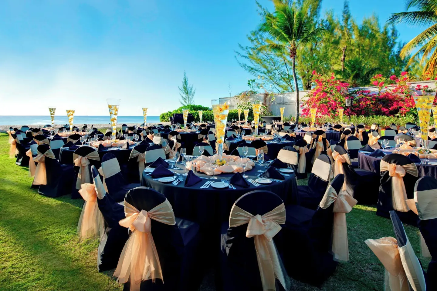 Outdoor event tables by the sea at The Westin Grand Cayman Seven Mile Beach Resort & Spa.