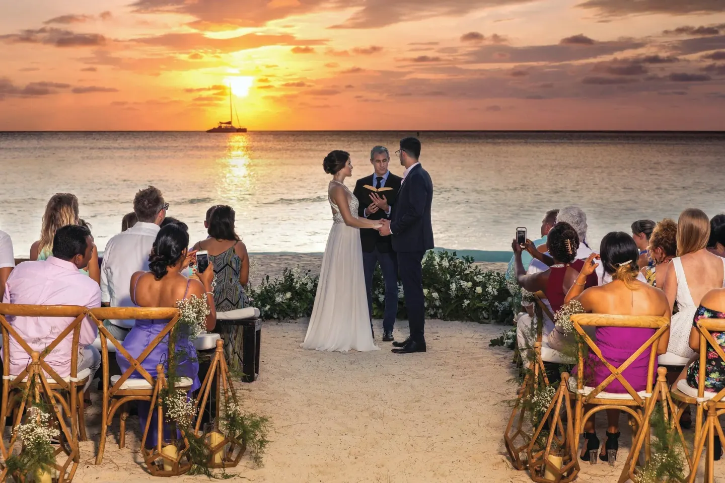 Sunset beach wedding ceremony at The Westin Grand Cayman Seven Mile Beach Resort & Spa.