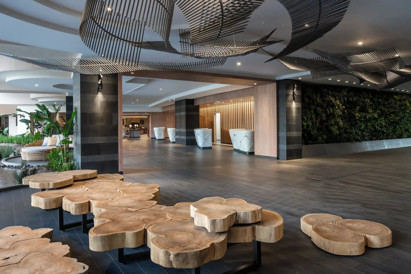 Modern lobby with wood slab tables and living wall at The Westin Maui Resort & Spa, Ka'anapali.