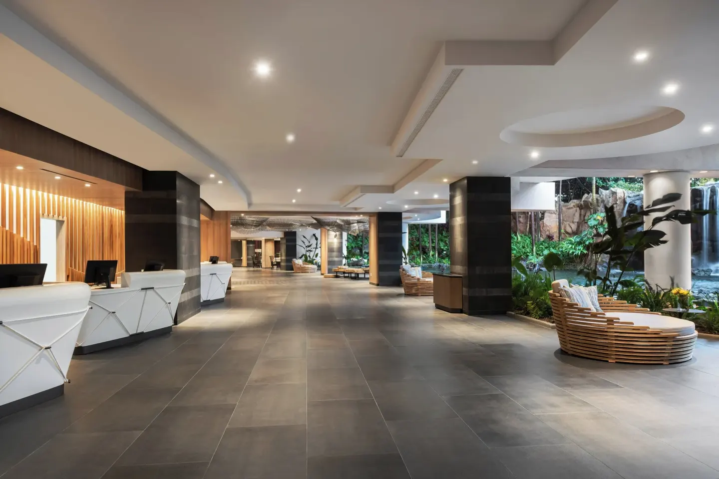 Reception area with white desks and waterfall garden at The Westin Maui Resort & Spa, Ka'anapali.