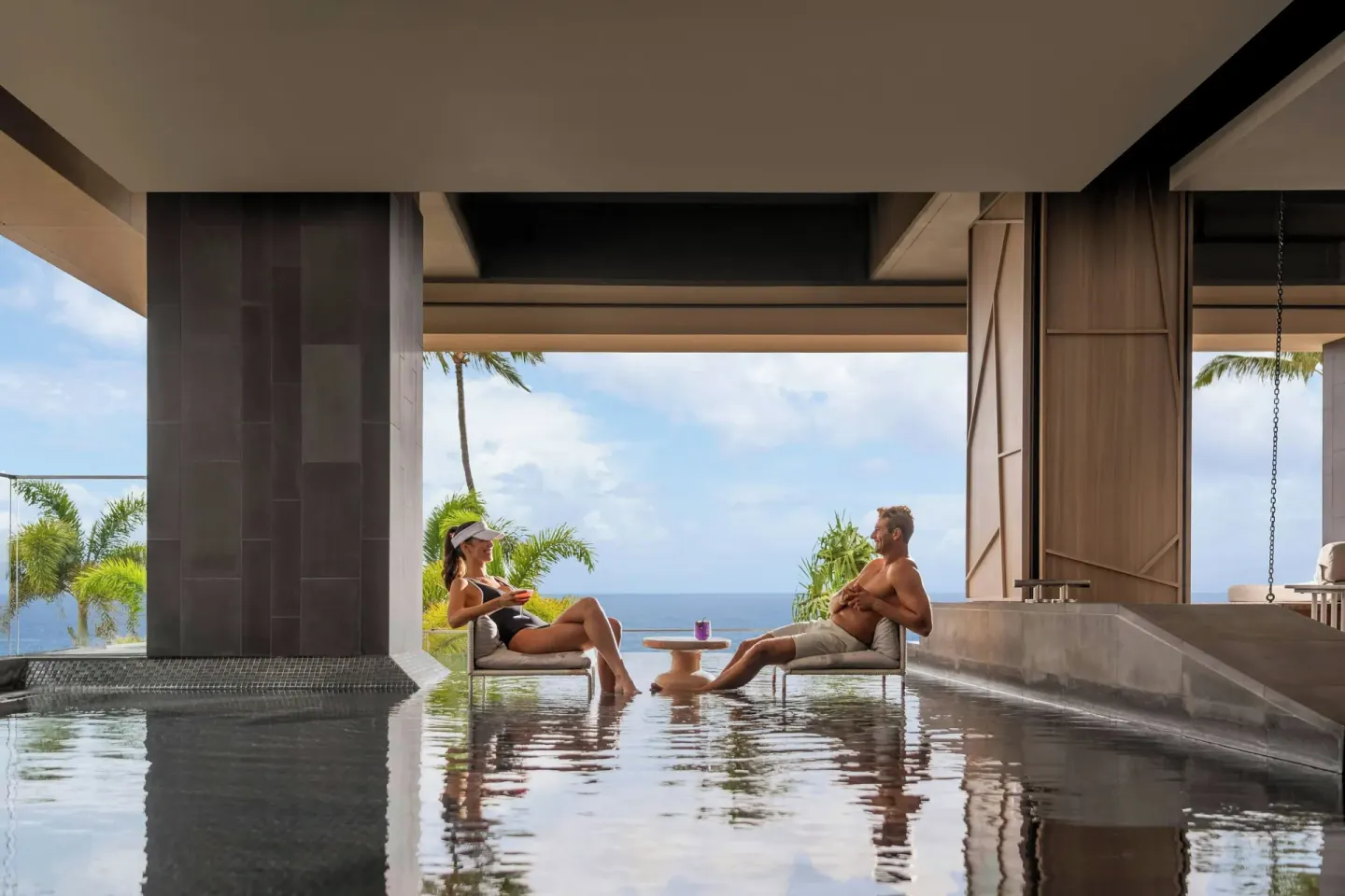 Guests sit in shallow spa water facing the ocean at The Westin Maui Resort & Spa, Ka'anapali.